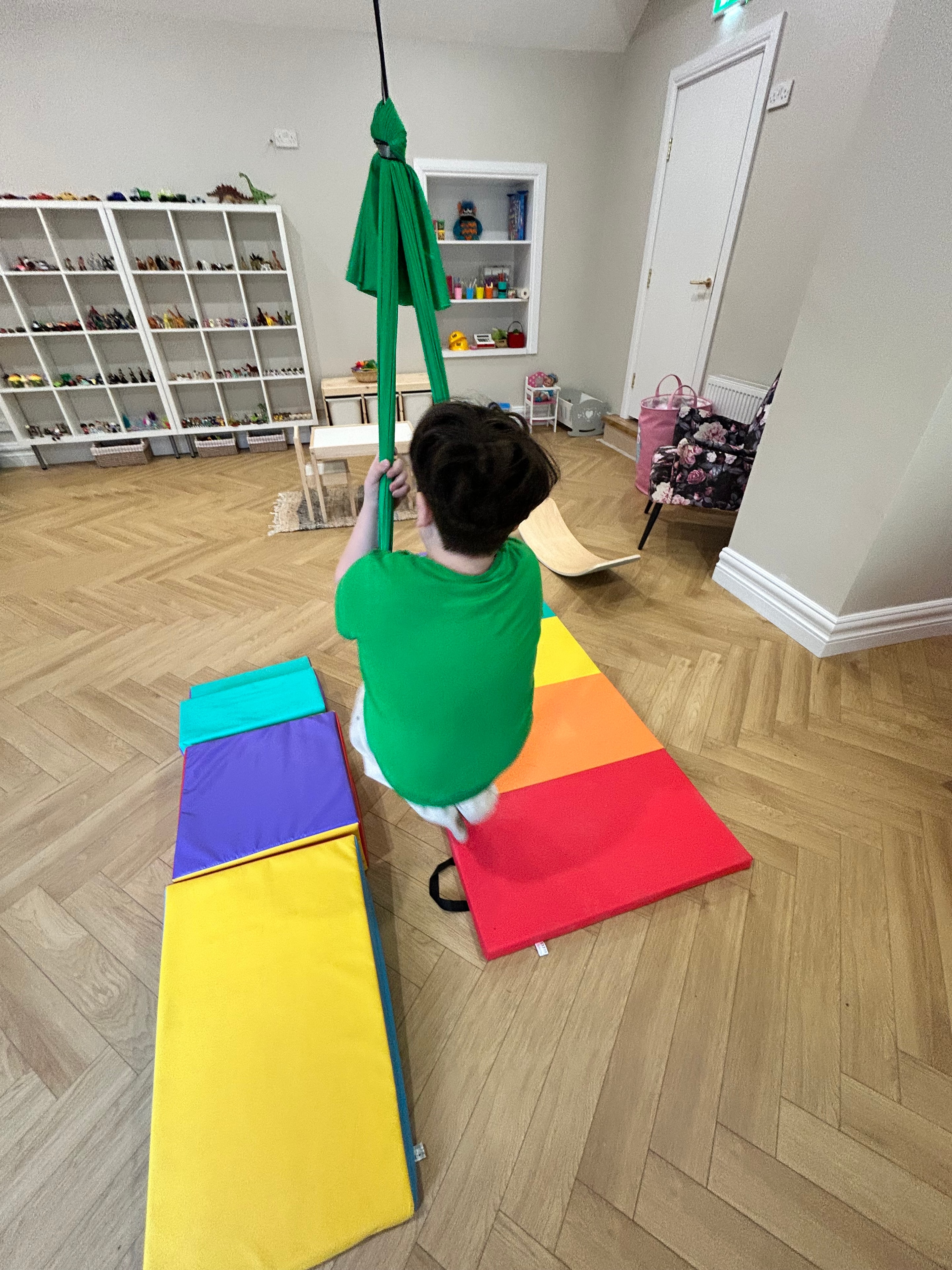 Child using the harness swing in the play therapy room